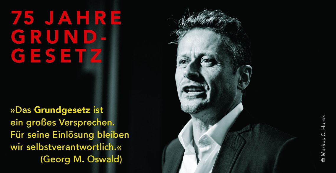KI generiert: Das Bild zeigt eine schwarz-weiße Porträtaufnahme eines Mannes neben einem Text, der das 75-jährige Jubiläum des Grundgesetzes hervorhebt. Neben dem Bild steht ein Zitat von Georg M. Oswald über die Verantwortung für die Einlösung des Grundgesetzes.